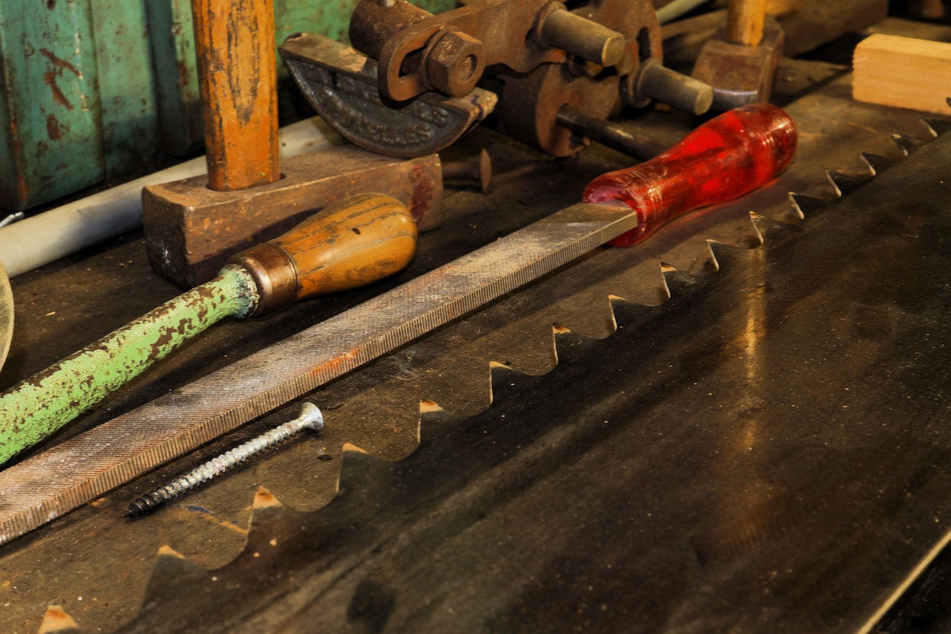Close-up of vintage woodworking tools on a wooden workbench, showcasing craftsmanship.